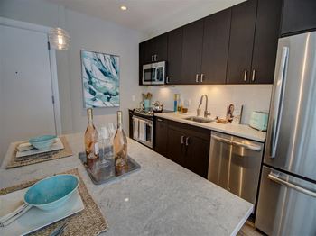 Fitted Kitchen With Island Dining at Via Seaport Residences, Massachusetts